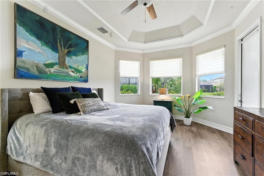 6899 Del Mar Terrace Naples, FL 34105 - Photo 22 of 41 a bed sitting in a bedroom next to a window