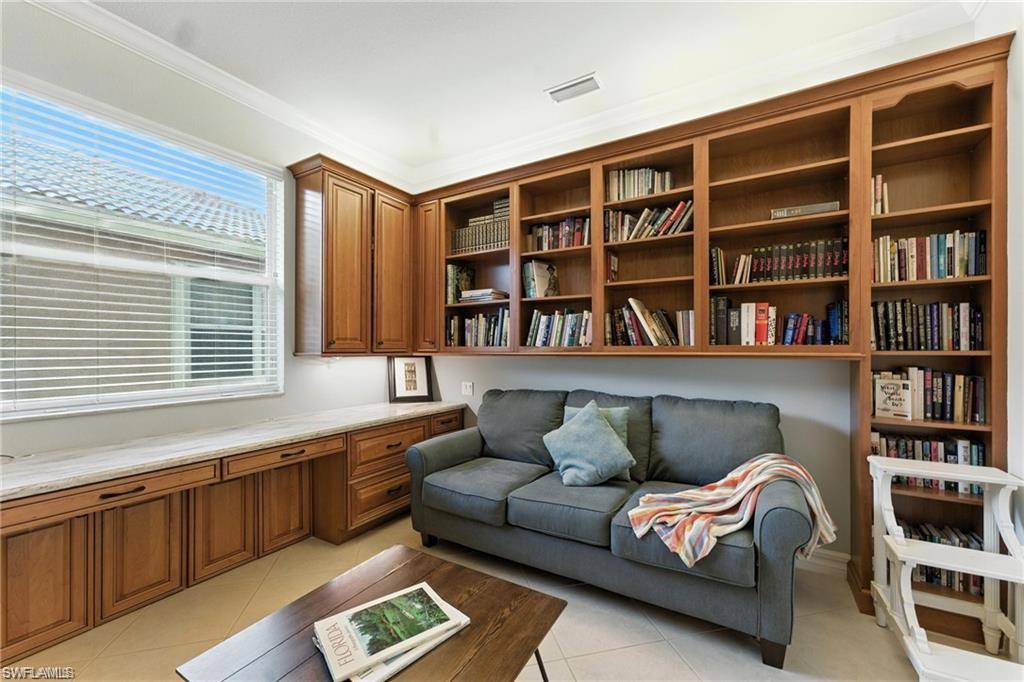 6899 Del Mar Terrace Naples, FL 34105 - Photo 26 of 41 a living room with furniture and book shelf