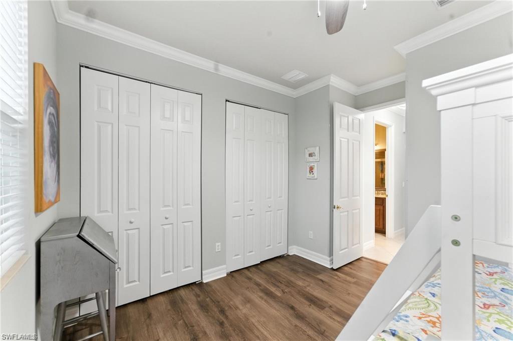 6899 Del Mar Terrace Naples, FL 34105 - Photo 28 of 41 a view of a bedroom with wooden floor