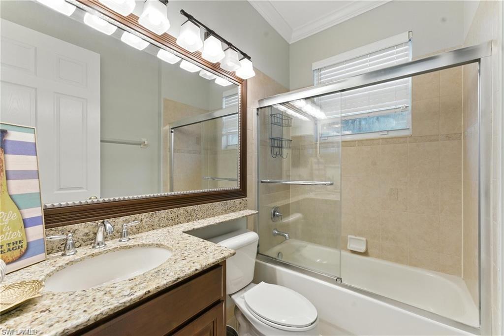 6899 Del Mar Terrace Naples, FL 34105 - Photo 30 of 41 a bathroom with a granite countertop sink toilet and shower
