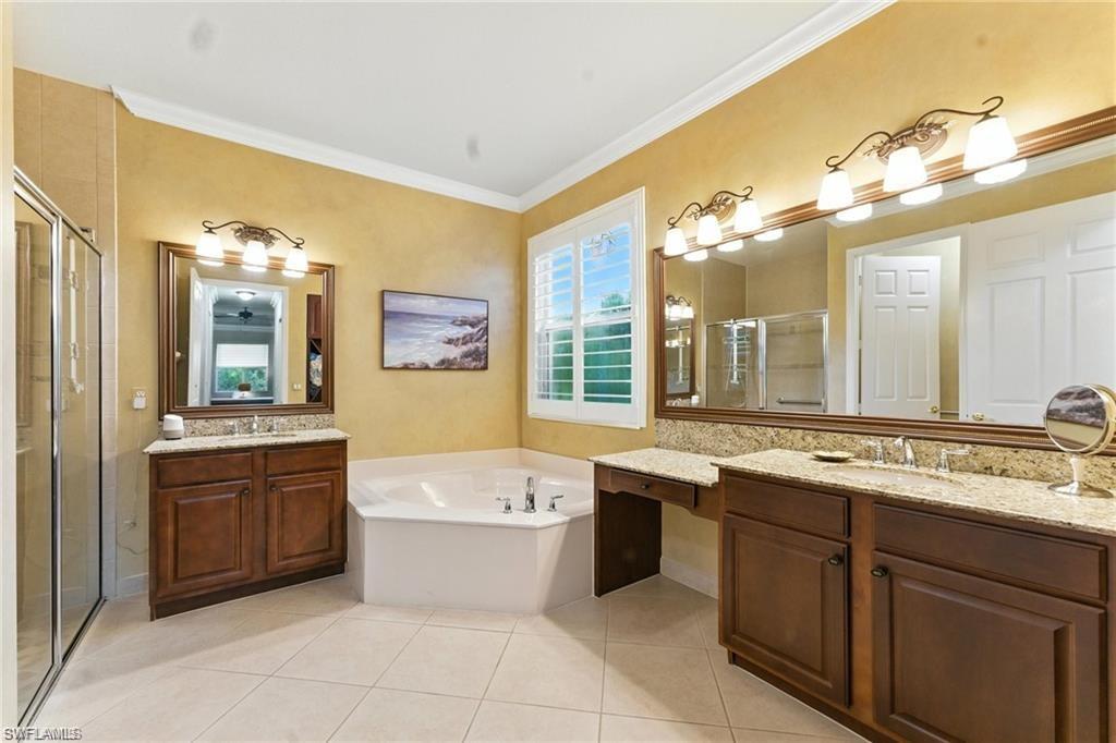 6899 Del Mar Terrace Naples, FL 34105 - Photo 32 of 41 a bathroom with a tub sink and mirror