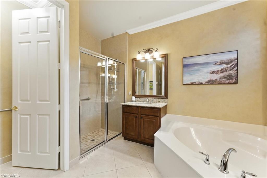 6899 Del Mar Terrace Naples, FL 34105 - Photo 33 of 41 a bathroom with a tub a sink and glass door