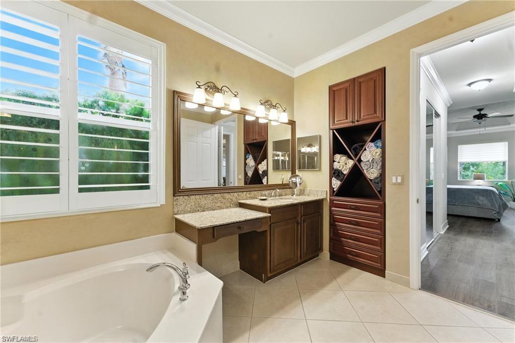 6899 Del Mar Terrace Naples, FL 34105 - Photo 34 of 41 a bathroom with a tub sink and mirror