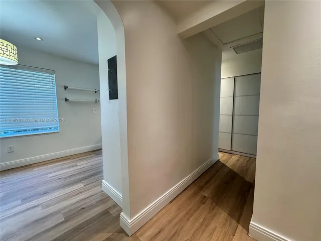 a view of empty room with wooden floor