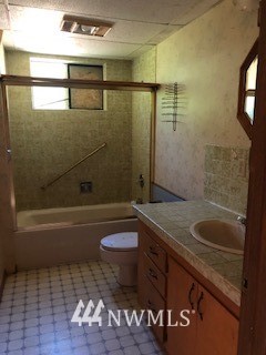 793 Rhoades Road Winlock, WA 98596 - Photo 24 of 24 a bathroom with a granite countertop sink a toilet and bathtub