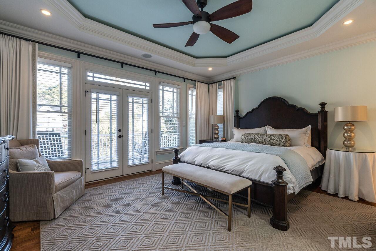 3024 Farrior Road Raleigh, NC 27607 - Photo 21 of 42 a spacious bedroom with a bed and glass walk in closet