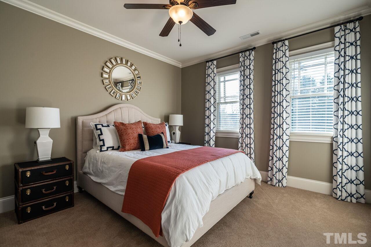 3024 Farrior Road Raleigh, NC 27607 - Photo 25 of 42 a bedroom with a bed and a chandelier
