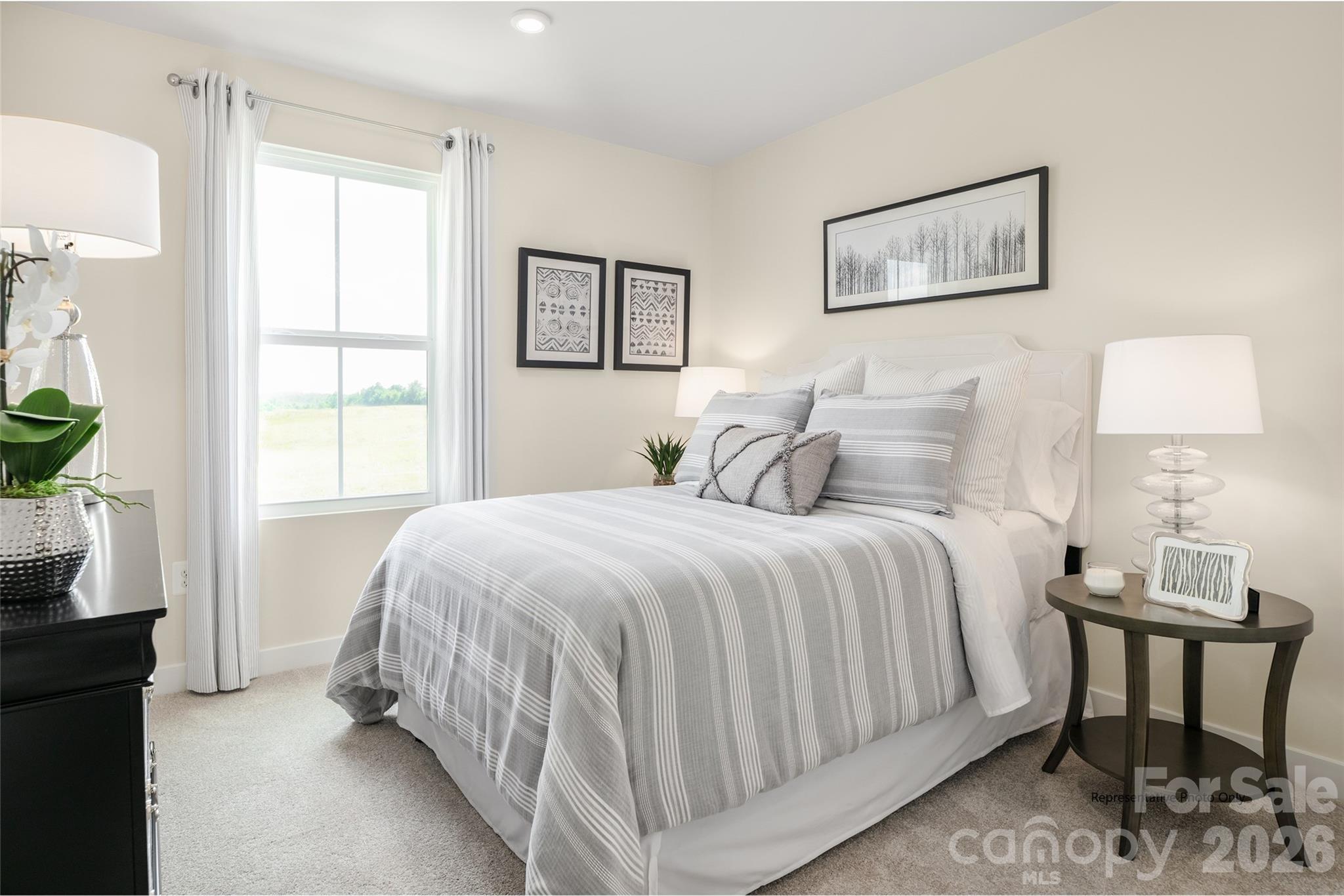1020 Bracken Hill Road Indian Trail, NC 28079 - Photo 9 of 28 a bedroom with a bed and a table