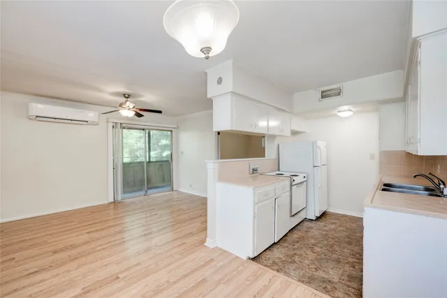 a kitchen with a sink a counter top space stainless steel appliances and a window