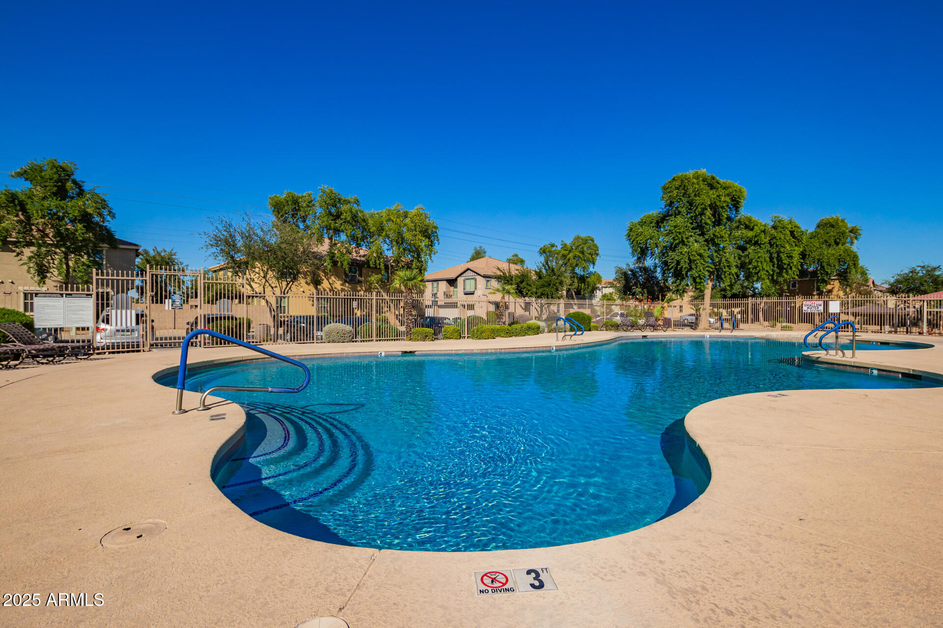 8117 West Groom Creek Road Phoenix, AZ 85043 - Photo 14 of 33 a view of a swimming pool with a house in the background