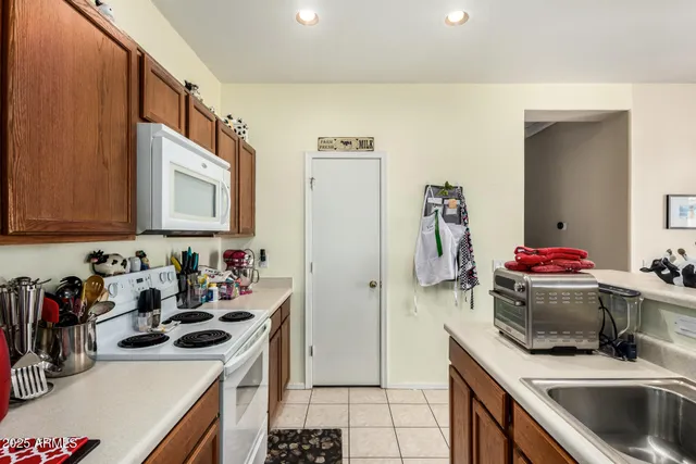 a kitchen with a sink stove and refrigerator