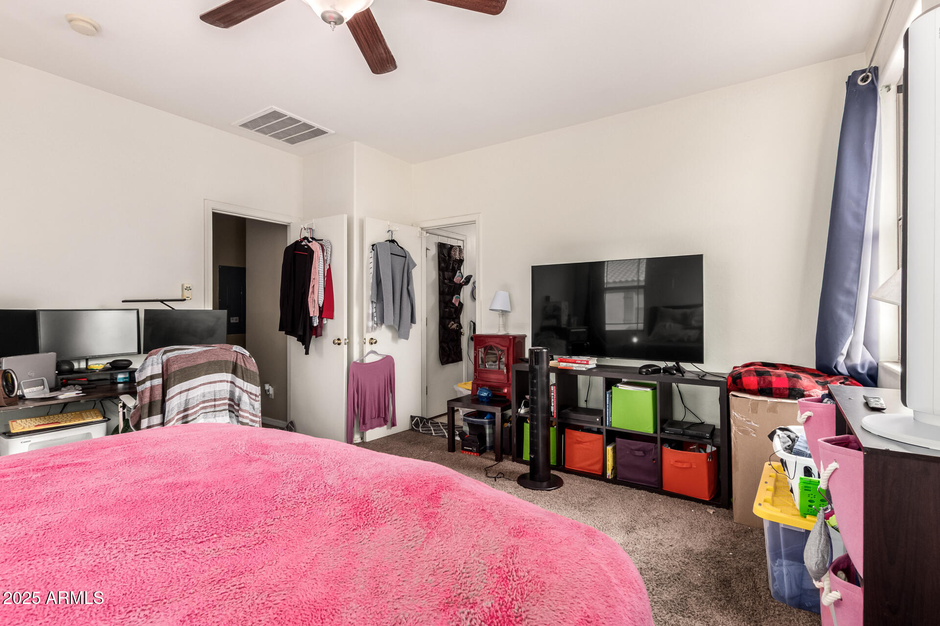 8117 West Groom Creek Road Phoenix, AZ 85043 - Photo 21 of 33 a bedroom with bed and a flat tv screen on the dresser