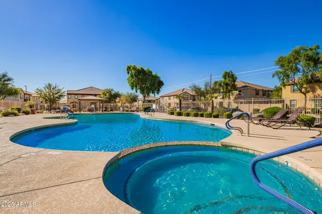 a view of a swimming pool with an outdoor seating and a yard