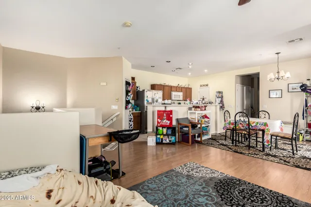 a bedroom with furniture and a wooden floor