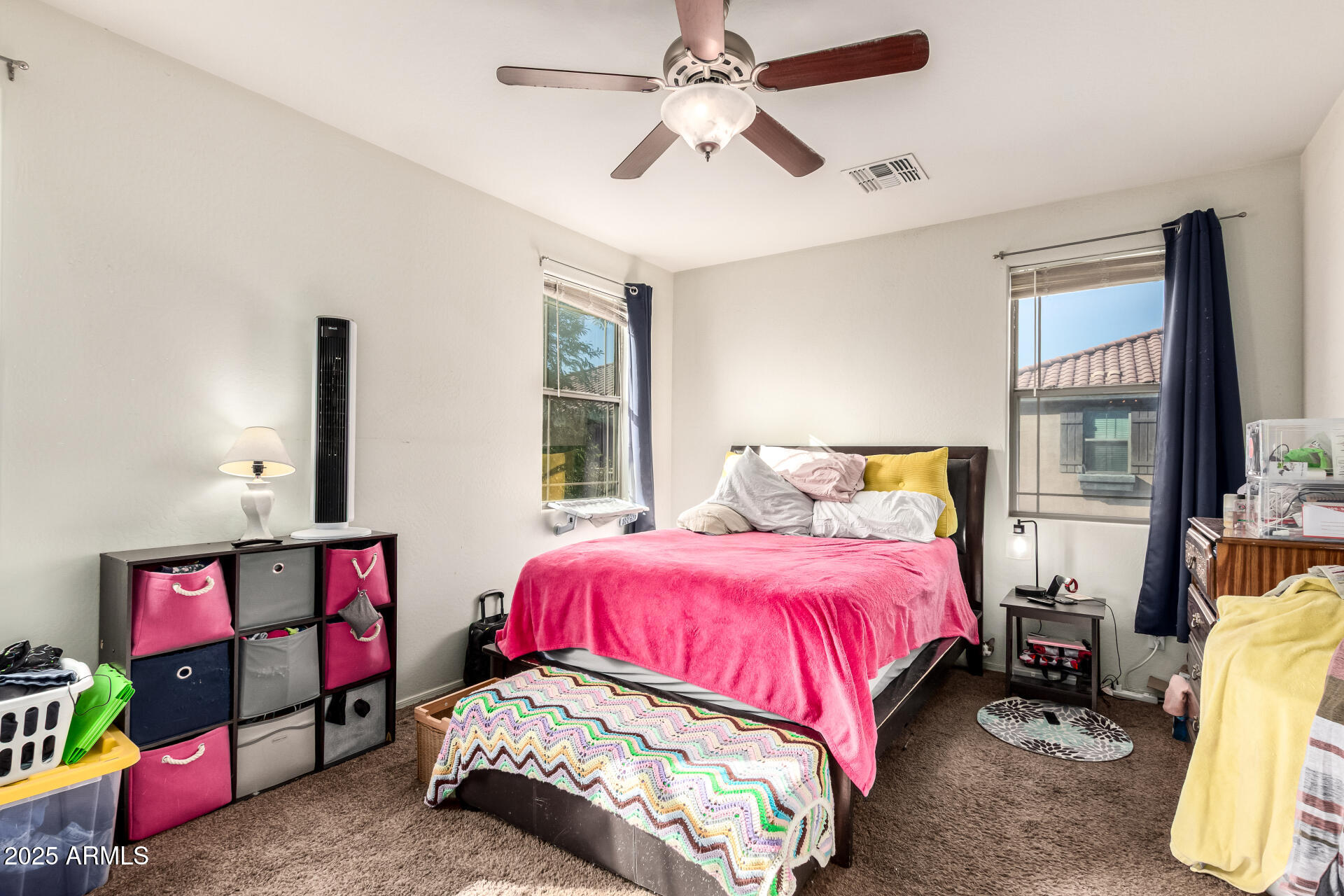 8117 West Groom Creek Road Phoenix, AZ 85043 - Photo 8 of 33 a bedroom with a bed and a chandelier