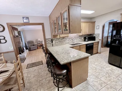 a kitchen with stainless steel appliances granite countertop a sink stove and cabinets