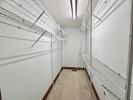 a view of a patio with couches and a table and chairs with wooden floor