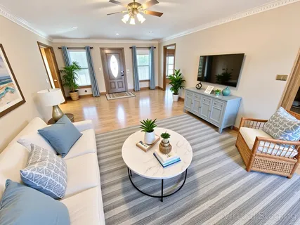 a living room with furniture and a flat screen tv