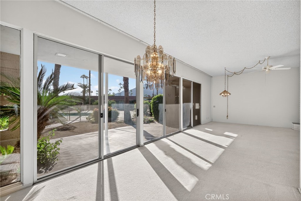 76695 Roadrunner Drive Indian Wells, CA 92210 - Photo 13 of 29 a view of a big room with wooden floor and windows