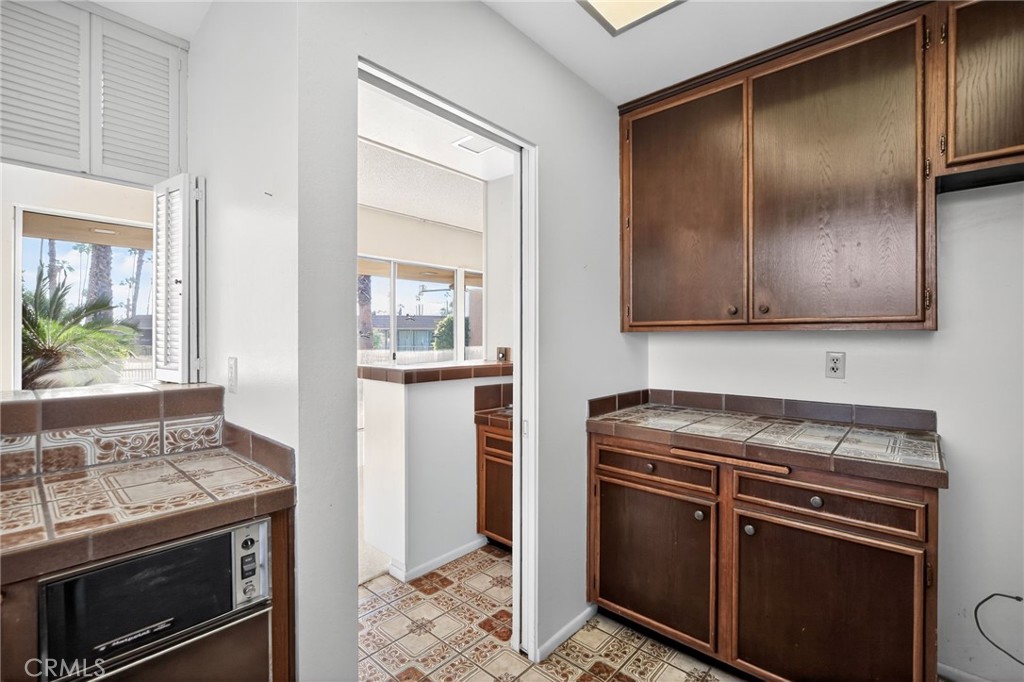 76695 Roadrunner Drive Indian Wells, CA 92210 - Photo 10 of 29 a kitchen with stainless steel appliances granite countertop a stove and a microwave with white countertops
