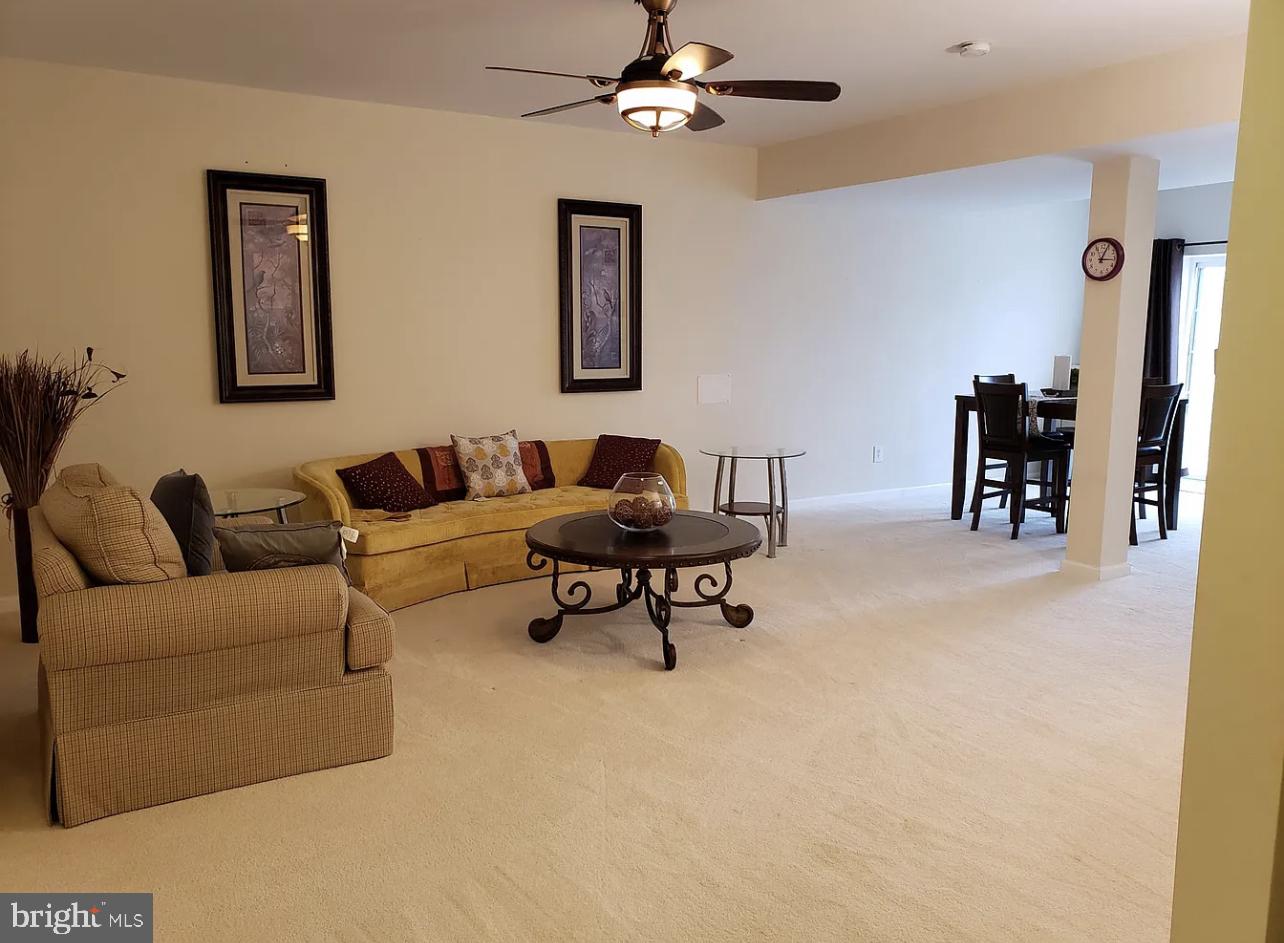 842 Kingsbrook Road Culpeper, VA 22701 - Photo 21 of 24 a living room with furniture and a chandelier