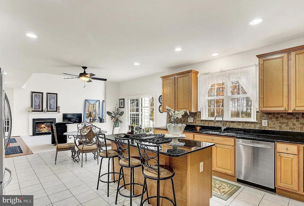 842 Kingsbrook Road Culpeper, VA 22701 - Photo 9 of 24 a kitchen with stainless steel appliances granite countertop a stove top oven a sink a dining table and chairs