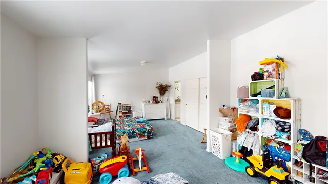 a bed room with lots of furniture and a window