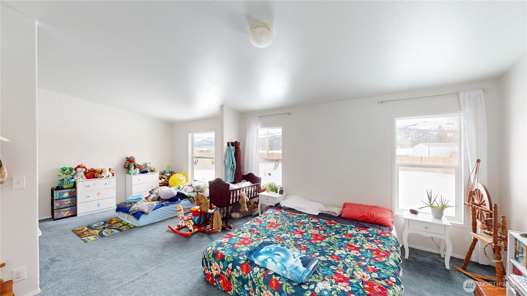 722 Aeneas Valley Road Tonasket, WA 98855 - Photo 18 of 35 a bed room with lots of furniture and a window