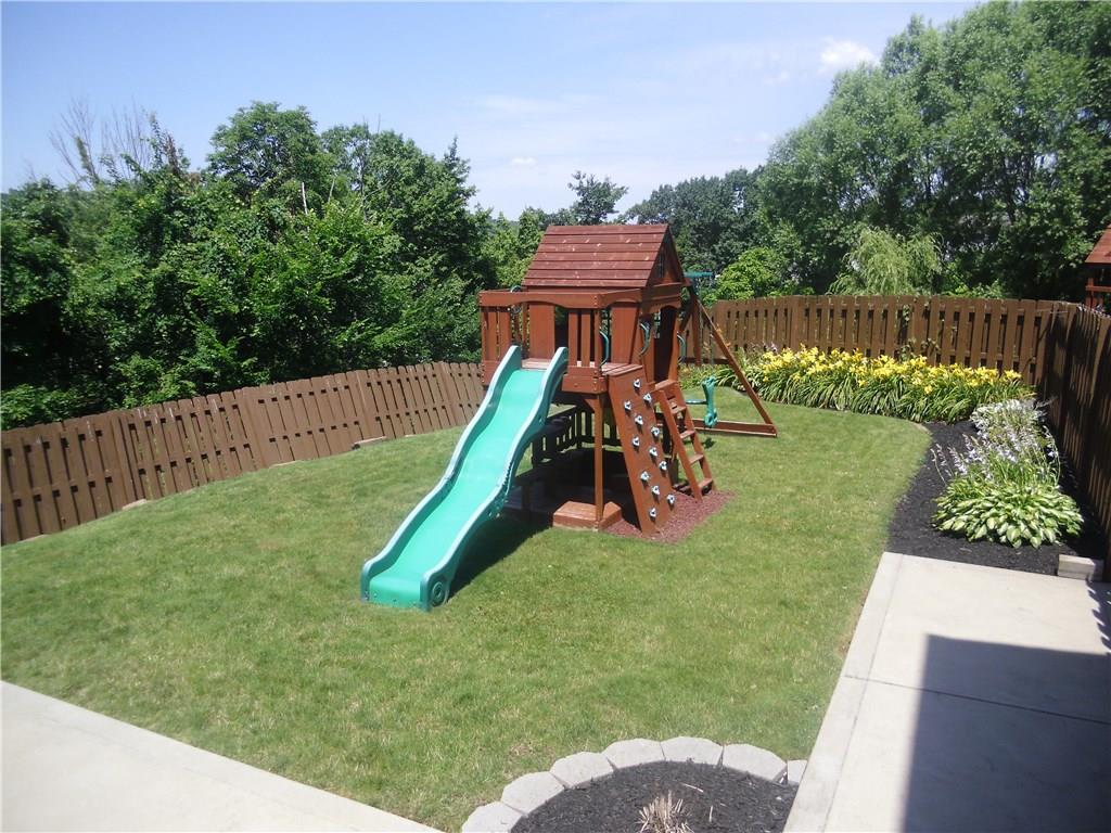 1119 Rural Ridge Drive Cheswick, PA 15024 - Photo 22 of 25 Backyard with beautiful perennials is fenced and play set stays.