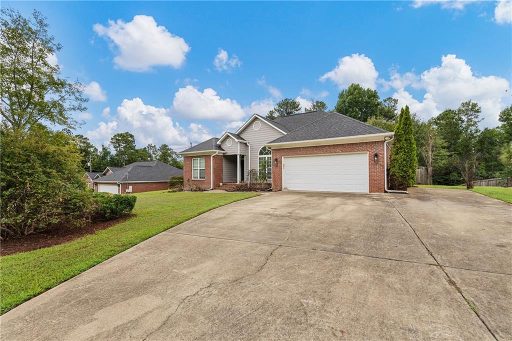 1449 Cummings Road Smiths Station, AL 36877 - Photo 2 of 28 Brick and siding exterior with an attached two-car garage