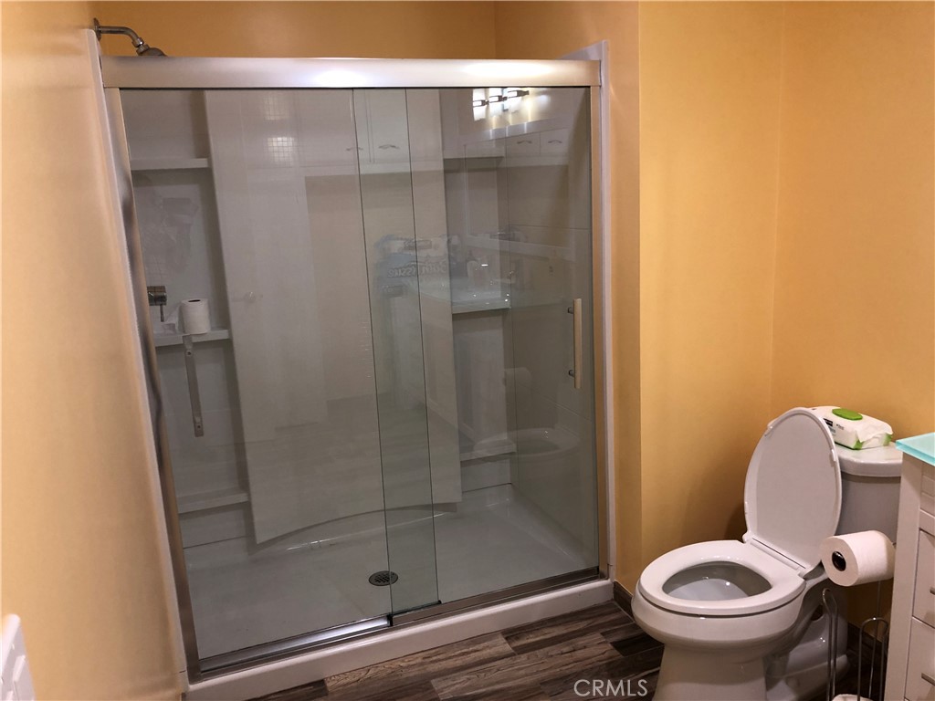 10404 Foothill Boulevard Sylmar, CA 91342 - Photo 13 of 29 a bathroom with a shower and toilet