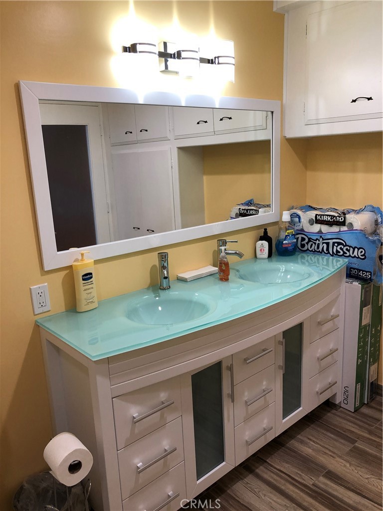 10404 Foothill Boulevard Sylmar, CA 91342 - Photo 14 of 29 a bathroom with a sink and a mirror