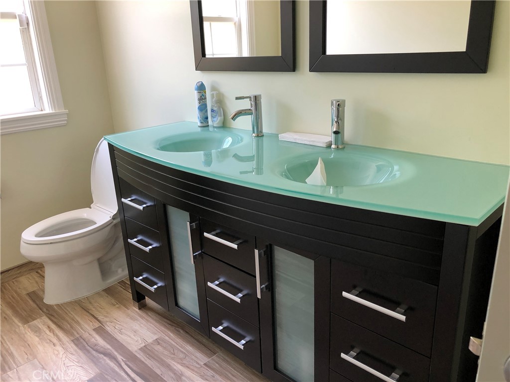 10404 Foothill Boulevard Sylmar, CA 91342 - Photo 10 of 29 a bathroom with a sink and a toilet