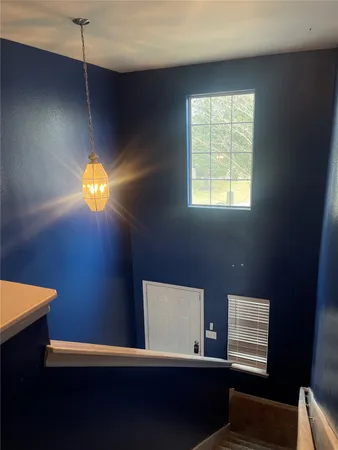 a workspace with furniture and two window