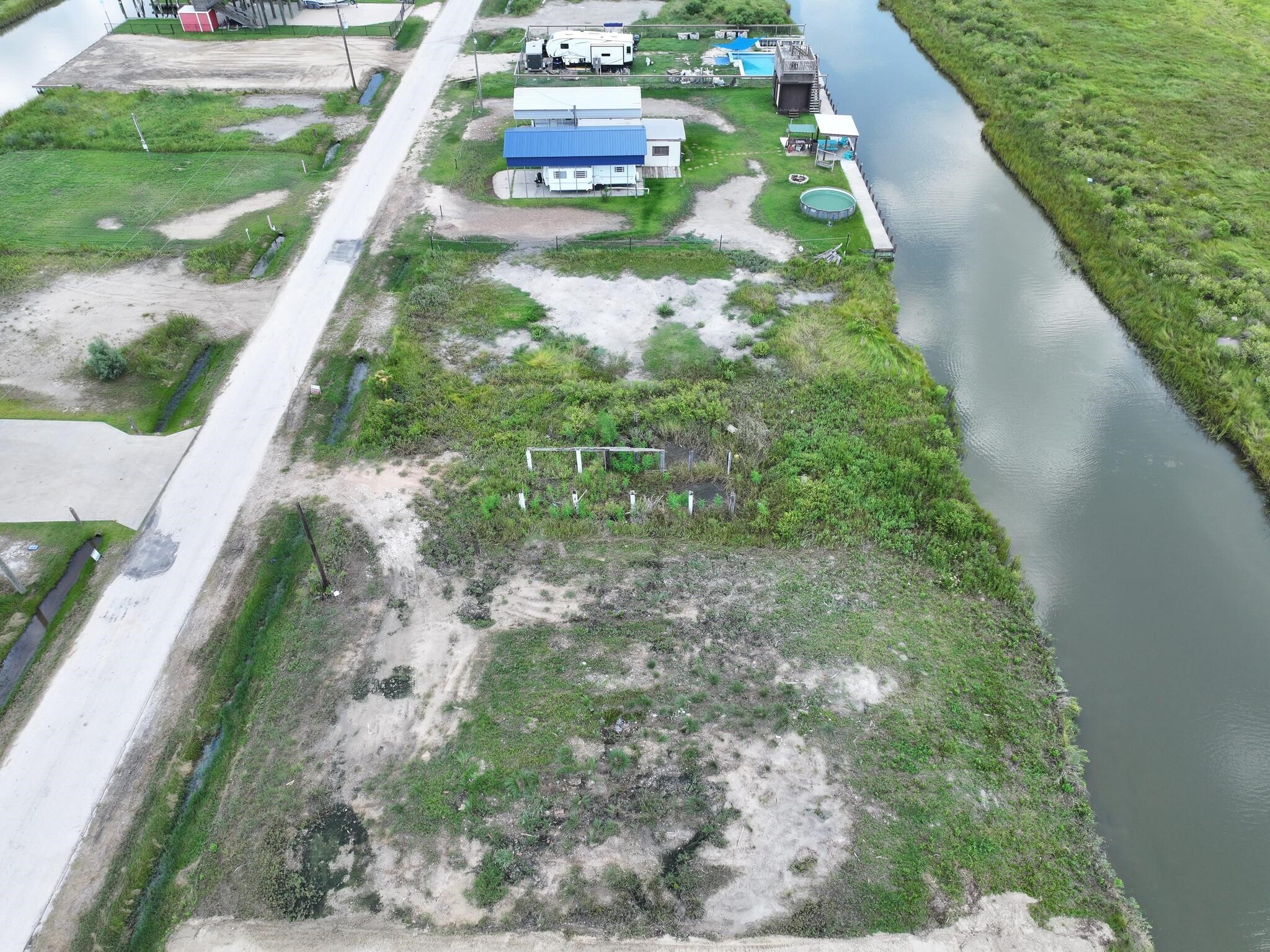 1392 Mabry Port Bolivar, TX 77650 - Photo 10 of 25 a backyard of a house with lots of green space