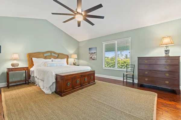 a bedroom with bed and a chandelier