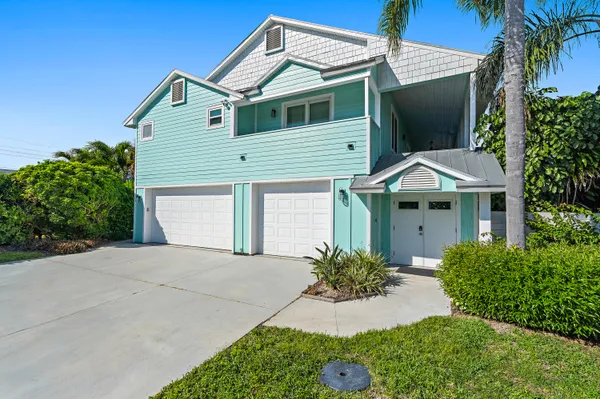 a view of a house with potted plants