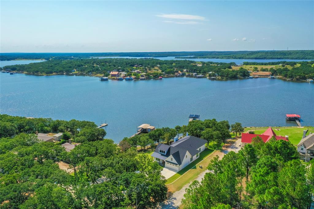 1757 Country Club Road Bowie, TX 76230 - Photo 1 of 40 an aerial view of ocean and residential houses with outdoor space