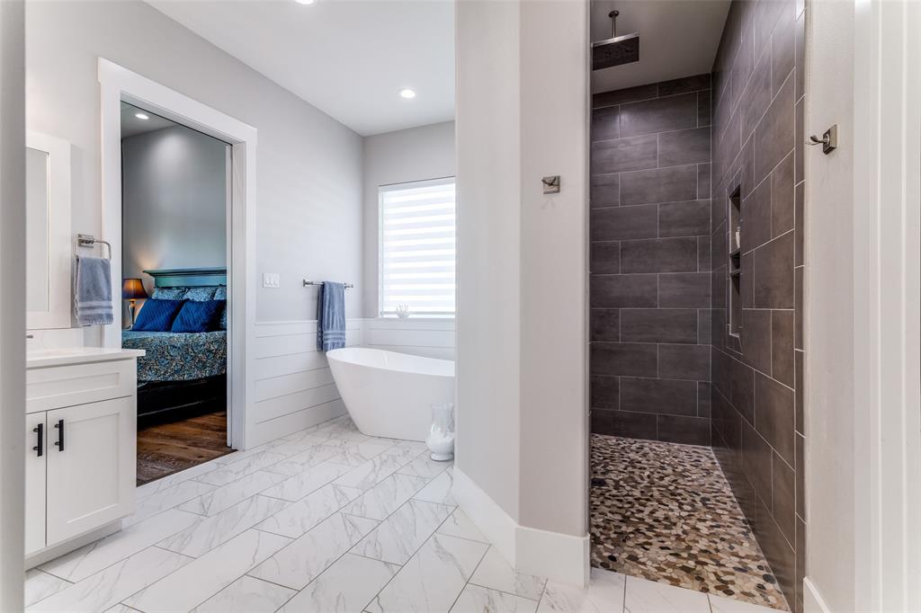 1757 Country Club Road Bowie, TX 76230 - Photo 19 of 40 a bathroom with a bathtub and a shower