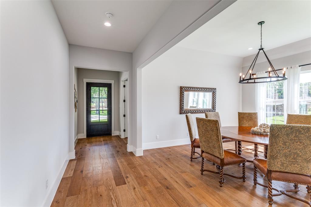 1757 Country Club Road Bowie, TX 76230 - Photo 21 of 40 a view of a dining room with furniture window and wooden floor
