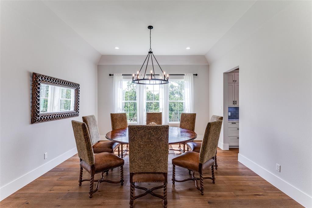 1757 Country Club Road Bowie, TX 76230 - Photo 23 of 40 a dining room with furniture a chandelier and wooden floor