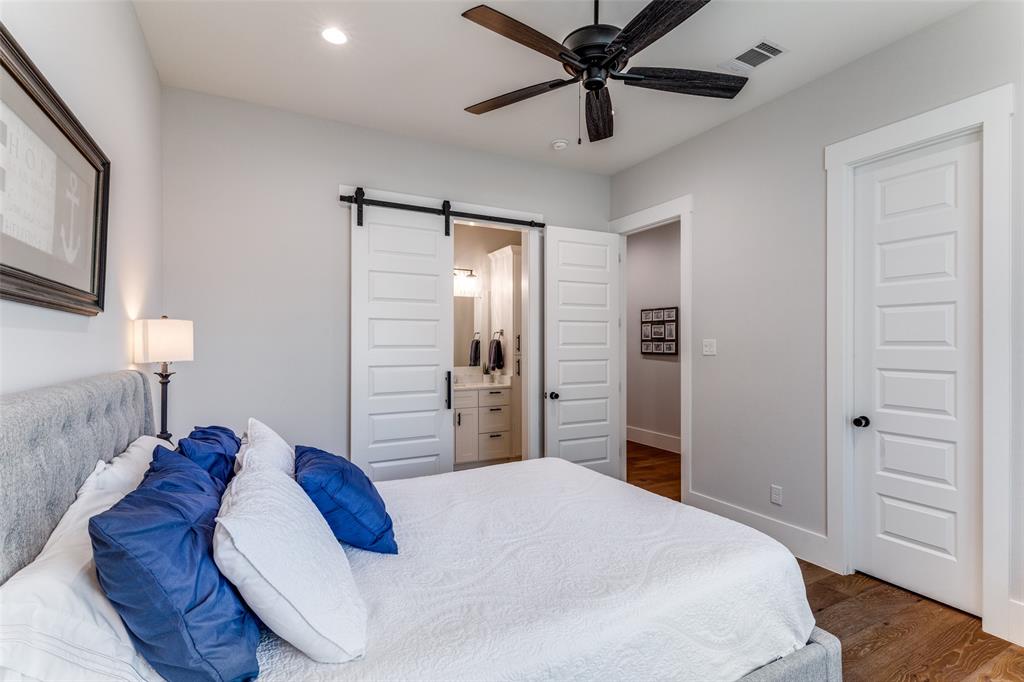 1757 Country Club Road Bowie, TX 76230 - Photo 25 of 40 a bedroom with a bed and a chandelier