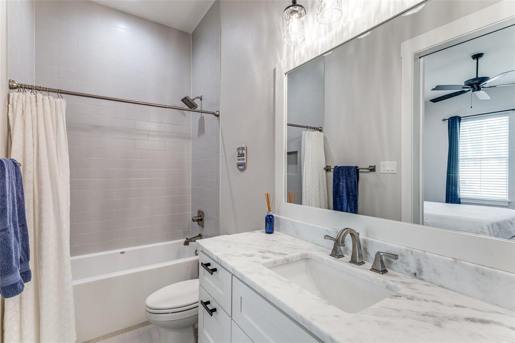 1757 Country Club Road Bowie, TX 76230 - Photo 26 of 40 a bathroom with a granite countertop sink toilet and shower