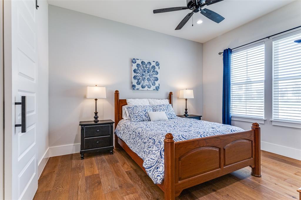 1757 Country Club Road Bowie, TX 76230 - Photo 27 of 40 a bedroom with a bed and wooden floor