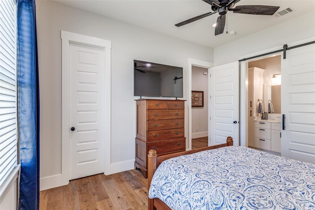 1757 Country Club Road Bowie, TX 76230 - Photo 28 of 40 a bedroom with a bed and wooden floor