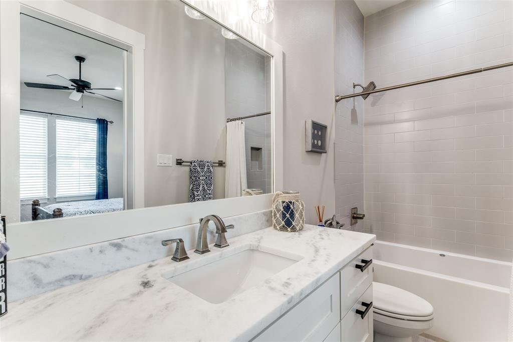 1757 Country Club Road Bowie, TX 76230 - Photo 29 of 40 a bathroom with a granite countertop sink a toilet and shower