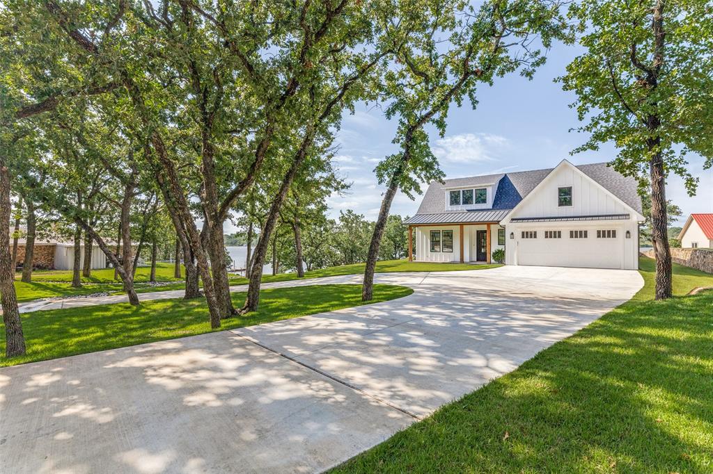 1757 Country Club Road Bowie, TX 76230 - Photo 4 of 40 a front view of a house with a yard and trees