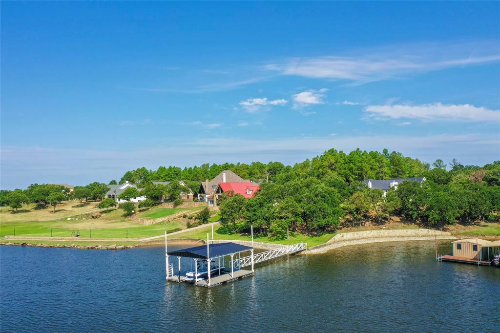 1757 Country Club Road Bowie, TX 76230 - Photo 6 of 40 a view of a lake with a house in the background