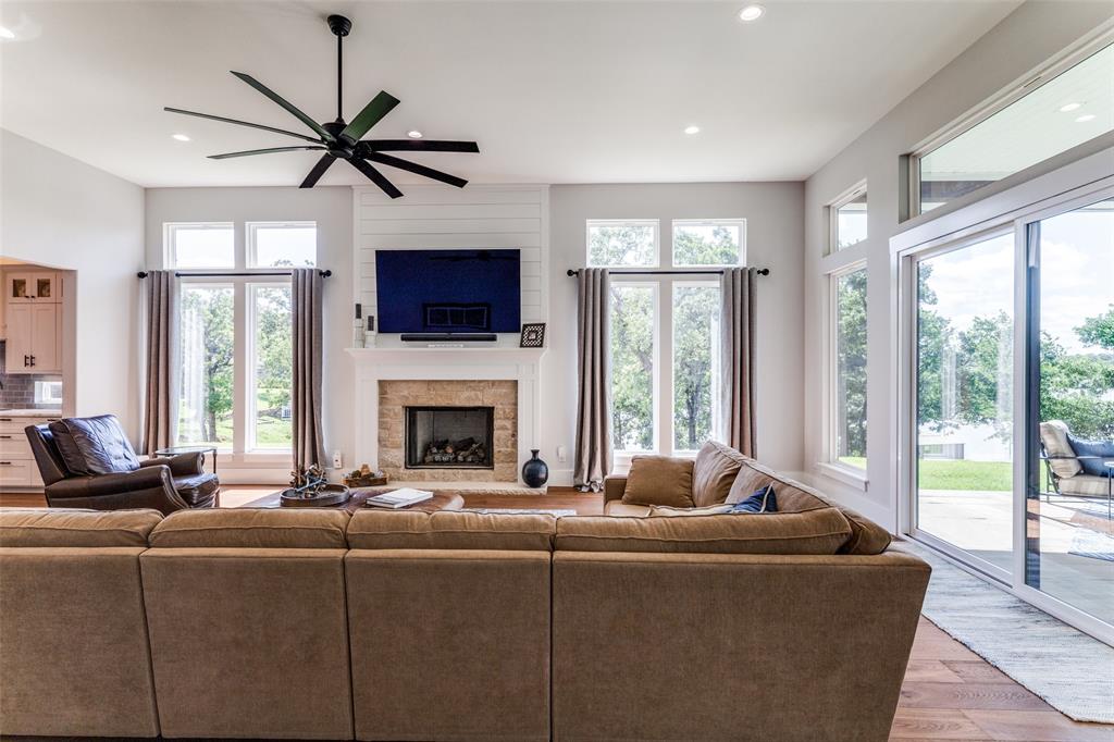 1757 Country Club Road Bowie, TX 76230 - Photo 9 of 40 a living room with furniture a flat screen tv and a large window
