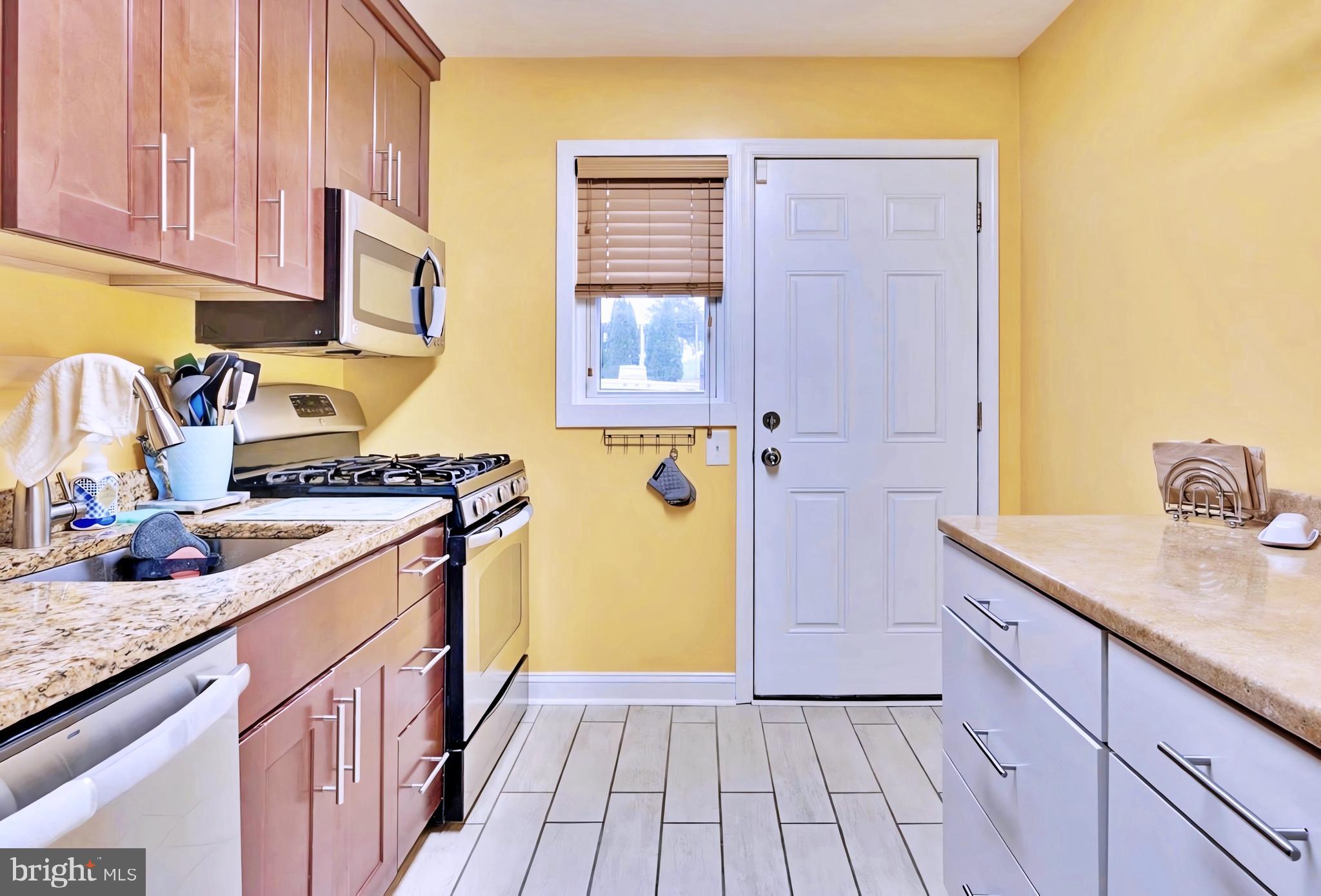 65 Garden Ridge Road Catonsville, MD 21228 - Photo 7 of 19 a kitchen with a sink stove and cabinets